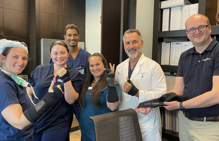 ucast team orthonow and badia hand to shoulder center