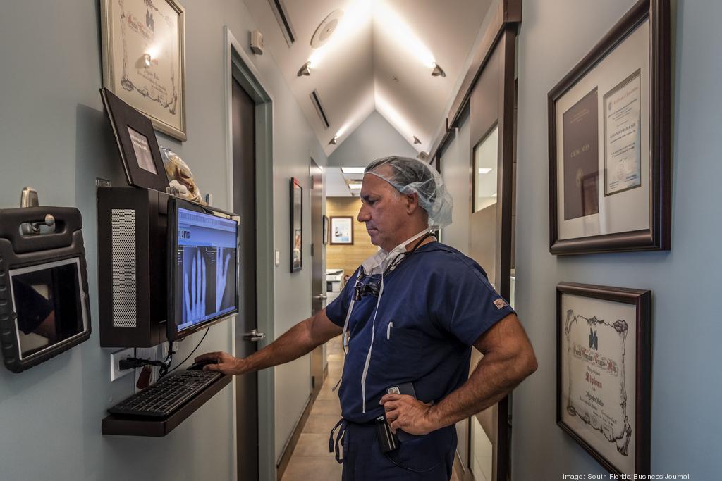 Dr. Badia looking at Xrays hand surgeon
