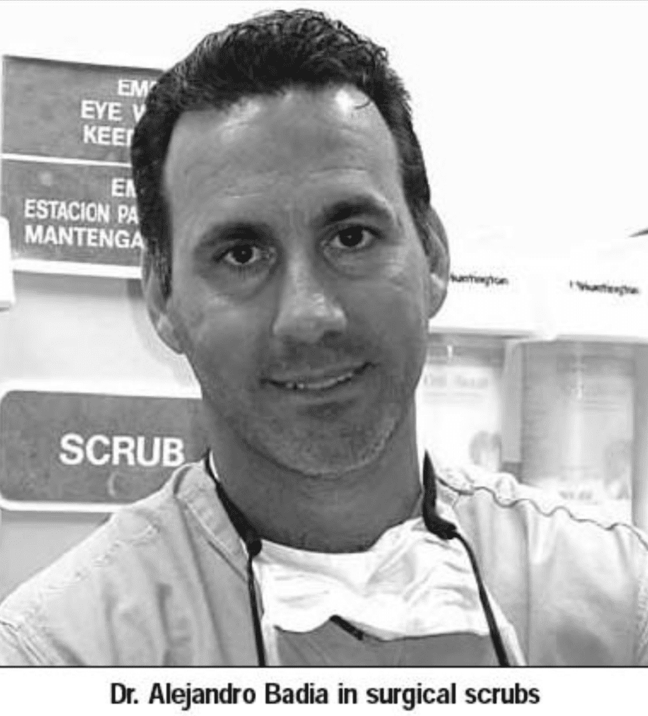 Black and white young Dr. Badia in scrubs