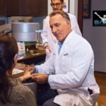 When and Why to Get a Second Opinion on Your Orthopedic Condition: Image of a patient discussing with an orthopedic surgeon, highlighting the importance of seeking a second opinion on surgical options.